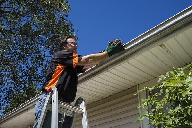 repairman sealing and reattaching a loose and sagging gutter in Bellflower